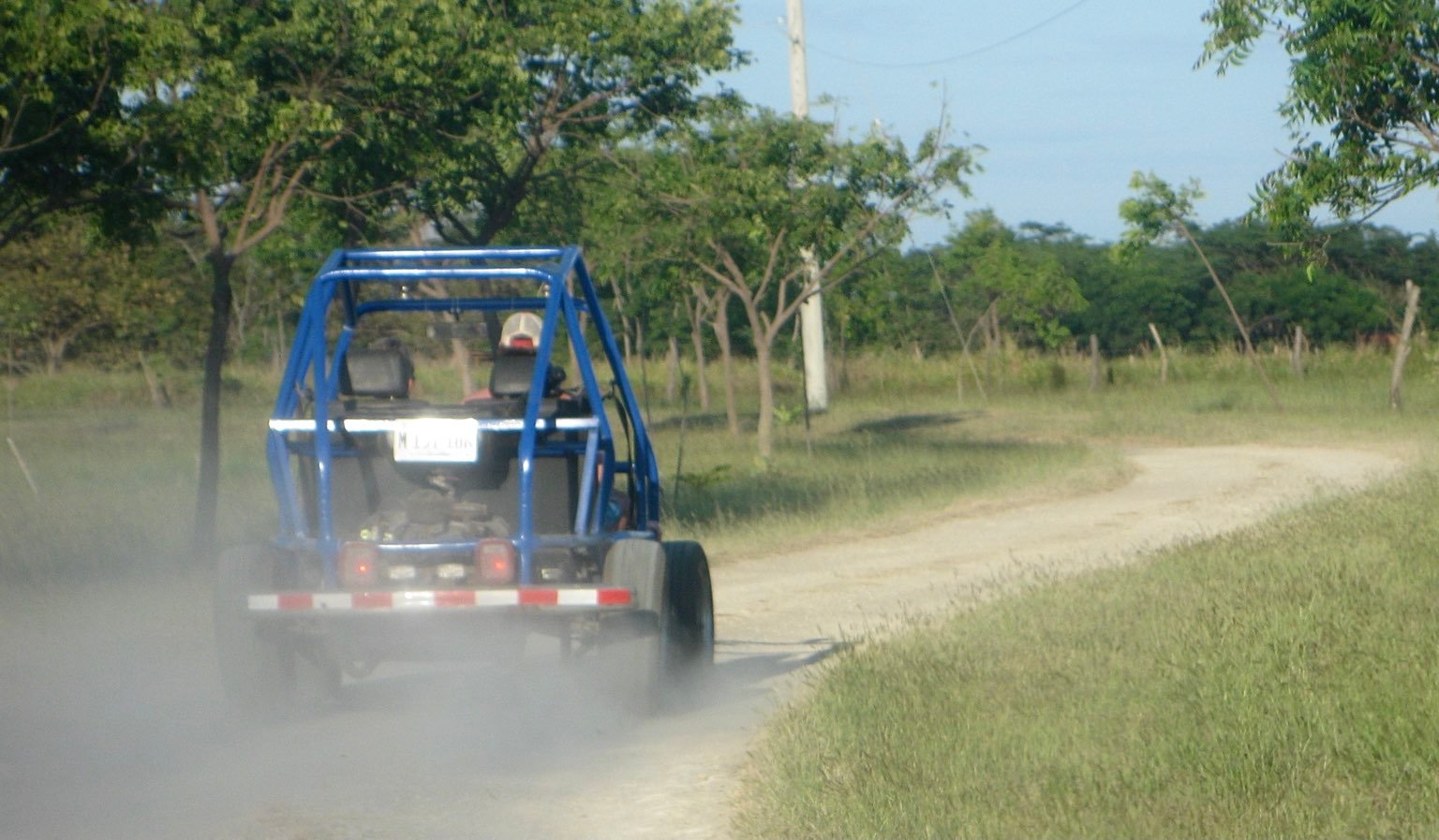 View of the buggy from behind, with a small dust cloud in its wake.
