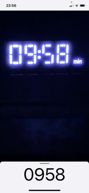 View of app in scanner mode. A timer with the digits 0 9 5 9 is visible in the camera window, and the digits 0 9 5 9 appear as the recognized text at the bottom of the app.