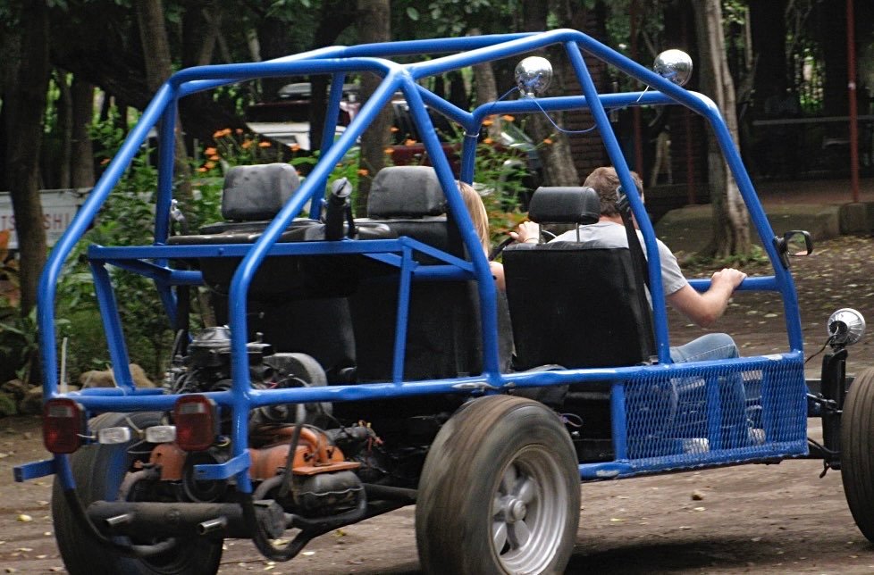 Looking at the dune buggy from the back. The engine is exposed.